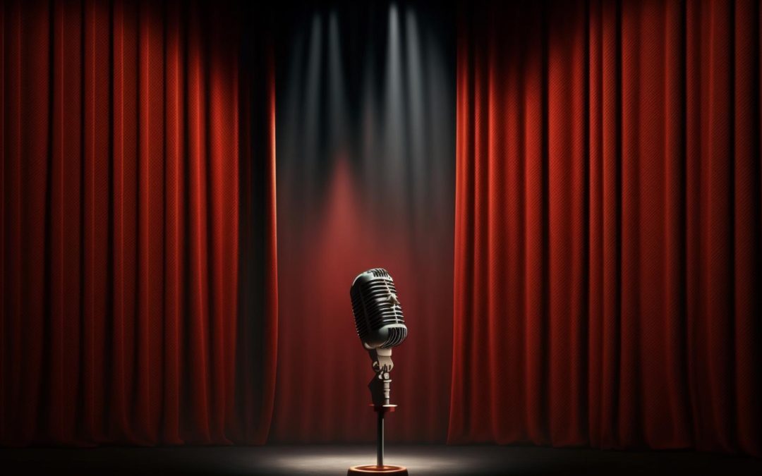 A vintage microphone on a stand is spotlighted in front of closed red theater curtains, setting the perfect stage for stand-up comedy.